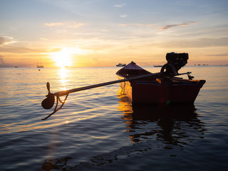 Long-tail Boat Floating On Crystal Clear Sea Water At Tropical Island in Thailand