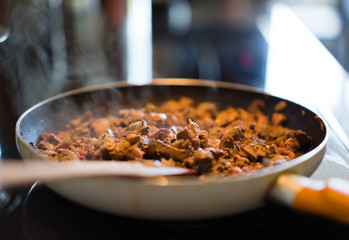 Sliced liver with spices and onion fried in pan