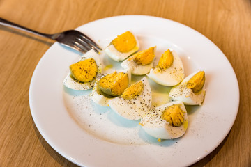 Boiled eggs with salt pepper and olive oil