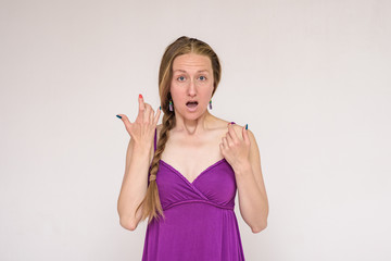 portrait of a beautiful surprised woman on a white background surprised.