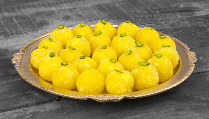 Indian Traditional Yellow Sweet Food Coconut Laddoo Also Know As Coconut Laddu, Ladoo, laddo Are Ball-Shaped Sweets on Wooden Background