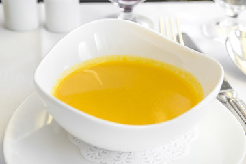 Set inflight meal soup on a tray, on a white table
