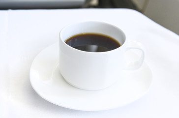 Set inflight meal appetizer coffee on a tray, on a white table