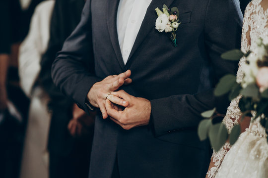 Wedding Couple Putting On Wedding Rings At Matrimony In Church. Stylish Bride And Groom Kissing And Exchanging Rings. Emotional Moment, Space For Text. Religion Concept