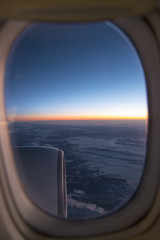 Fototapeta premium Clouds and sky as seen through window of an aircraft