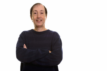 Studio shot of happy mature man smiling with arms crossed