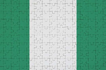 Nigeria flag  is depicted on a folded puzzle