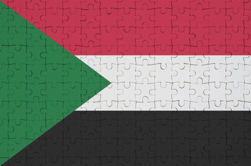 Sudan flag  is depicted on a folded puzzle