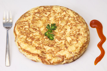 spanish omelette dish of potatoes and eggs with tomato sauce