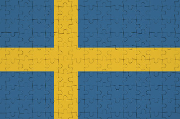 Sweden flag  is depicted on a folded puzzle