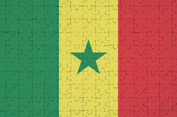Senegal flag  is depicted on a folded puzzle
