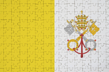 Vatican City State flag  is depicted on a folded puzzle