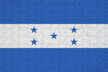 Honduras flag  is depicted on a folded puzzle