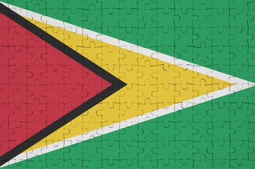 Guyana flag  is depicted on a folded puzzle