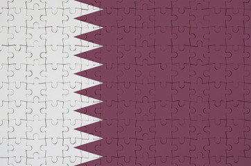 Qatar flag  is depicted on a folded puzzle