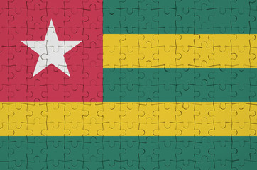 Togo flag  is depicted on a folded puzzle