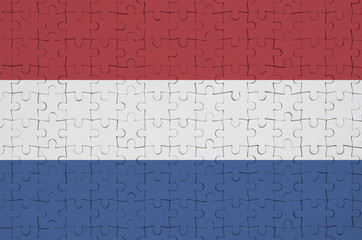 Netherlands flag  is depicted on a folded puzzle