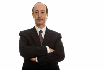 Studio shot of mature businessman with arms crossed