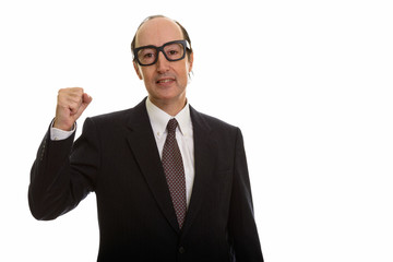 Studio shot of happy mature businessman smiling and looking moti