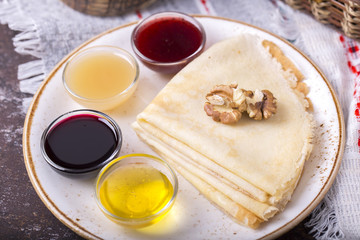 Tasty pancakes with different sauces. Sweet dessert