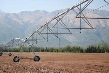 Industrial irrigation system on a field. Agricultural landscape in springtime