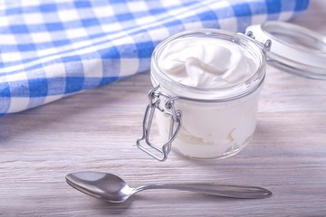 Sour cream in a glass jar. Homemade sour cream