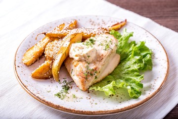 Fried chicken fillet with a pear and sauce of Dorblu