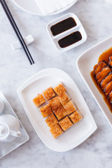 Golden Crispy Pork Belly cut in cube with chopsticks.