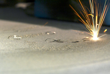 3D printer printing metal. Laser sintering machine for metal. Metal is sintered under the action of...
