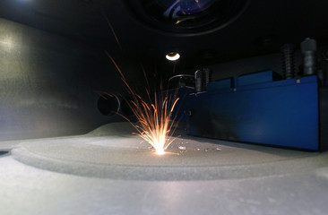 3D printer printing metal. Laser sintering machine for metal. Metal is sintered under the action of...