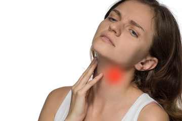 Beautiful woman holding her neck, because she hurts against a white background
