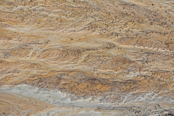 Beautiful sand patterns on the shore of baltic sea. Abstract, colorful background of sand on the beach. Shallow depth of field.
