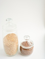 transparent glass containers with lentils and buckwheat on a light background