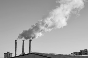 industrial smoke from chimney on sky. Black and white image