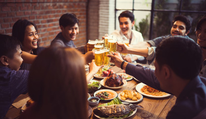 People in asian are celebrating the festival they clink glasses beer and dinner happy