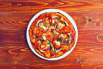 Home pizza, the best healthy men's breakfast. Top view, on a wooden table.