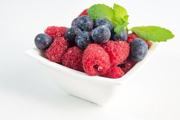 Berries with mint on white background