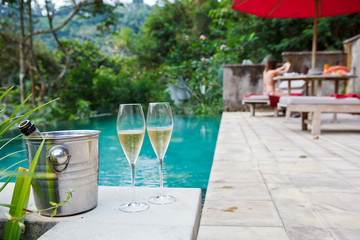 glasses of champagne near pool