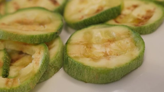 Heat evaporates from grilled zucchini cuts close-up footage - Hot Pepo cylindrica slices 