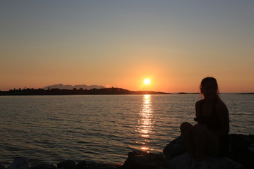 Girl in sunset in harbor in Northern Norway