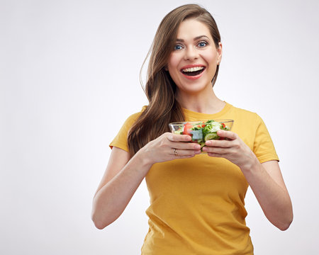 Smiling girl holding bowl with healthy  green food salad.