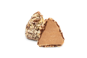 Half of chocolate candy with whole candy on white background.