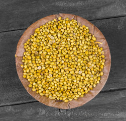 Dried Coriander Seeds or Dhaniya on Wooden Background