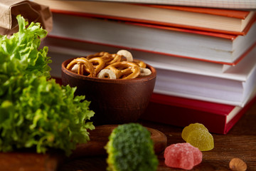 Concept of school lunch break with healthy lunch box and school supplies on wooden desk, selective focus.