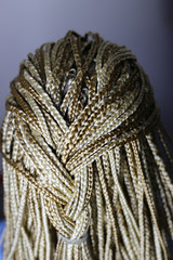 Fototapeta premium many African thin braids braided on the head of a blonde girl