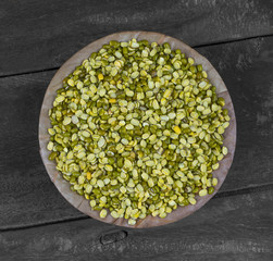 Raw Split Mung Bean Lentils or Mung Daal on Wooden Background