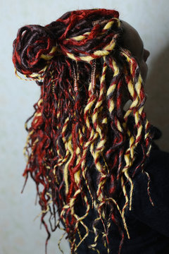 girl with a youth hairdress dreadlocks, a master, a beauty salon, the result of a hairdresser's work