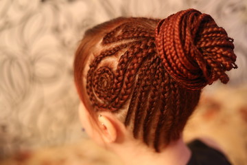 Girl. red hair braided in braids, gathered in the tail on the back of the head, close-up hair