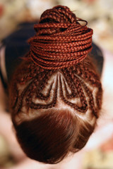 Girl. red hair braided in braids, gathered in the tail on the back of the head, close-up hair