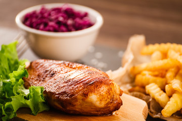 Grilled chicken breast, French fries and vegetables